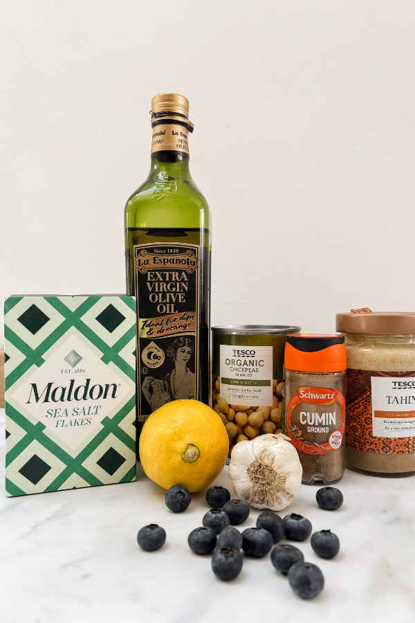 Ingredients for the blueberry hummus against a white background