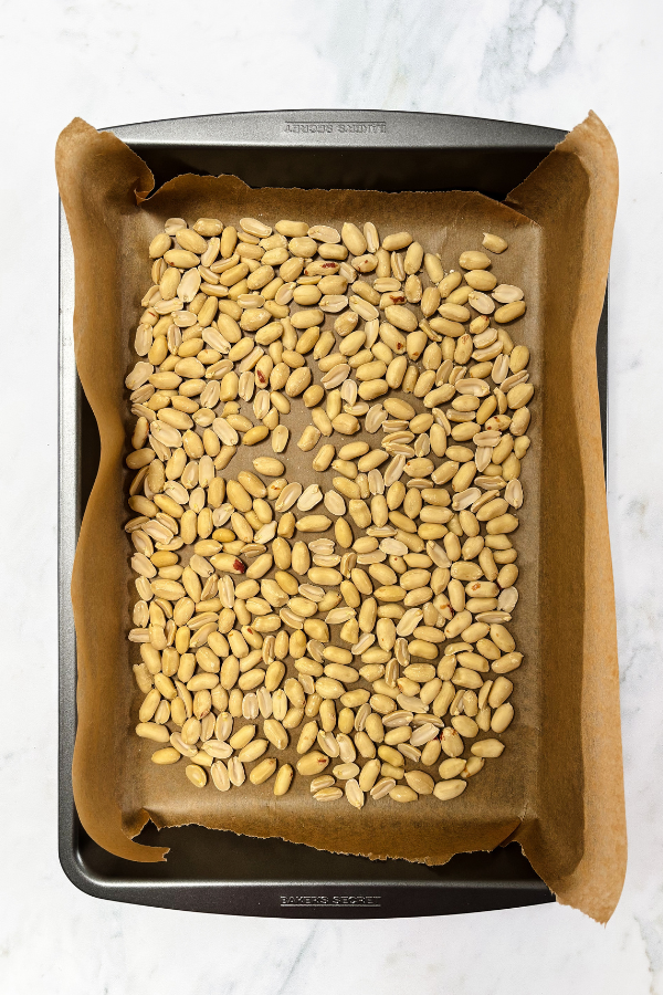 300g of peanuts on a roasting tray ready to go in the oven